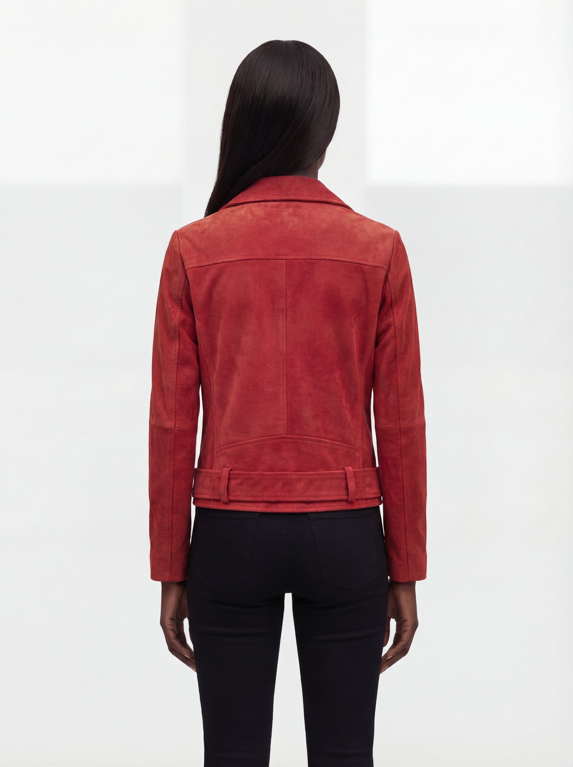Rear view of female model wearing Maverick Ember suede jacket showing structured shoulder fit and belted hem styling. Maverick Jacket.
