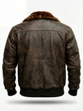 Rear view of distressed brown leather aviator jacket showing central vertical seam and shoulder yoke paneling. The Corsair by Maverick Jacket.