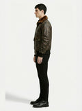 Side profile of Maverick Corsair aviator jacket showing ribbed cuff structure and relaxed bomber silhouette. Maverick Jacket.