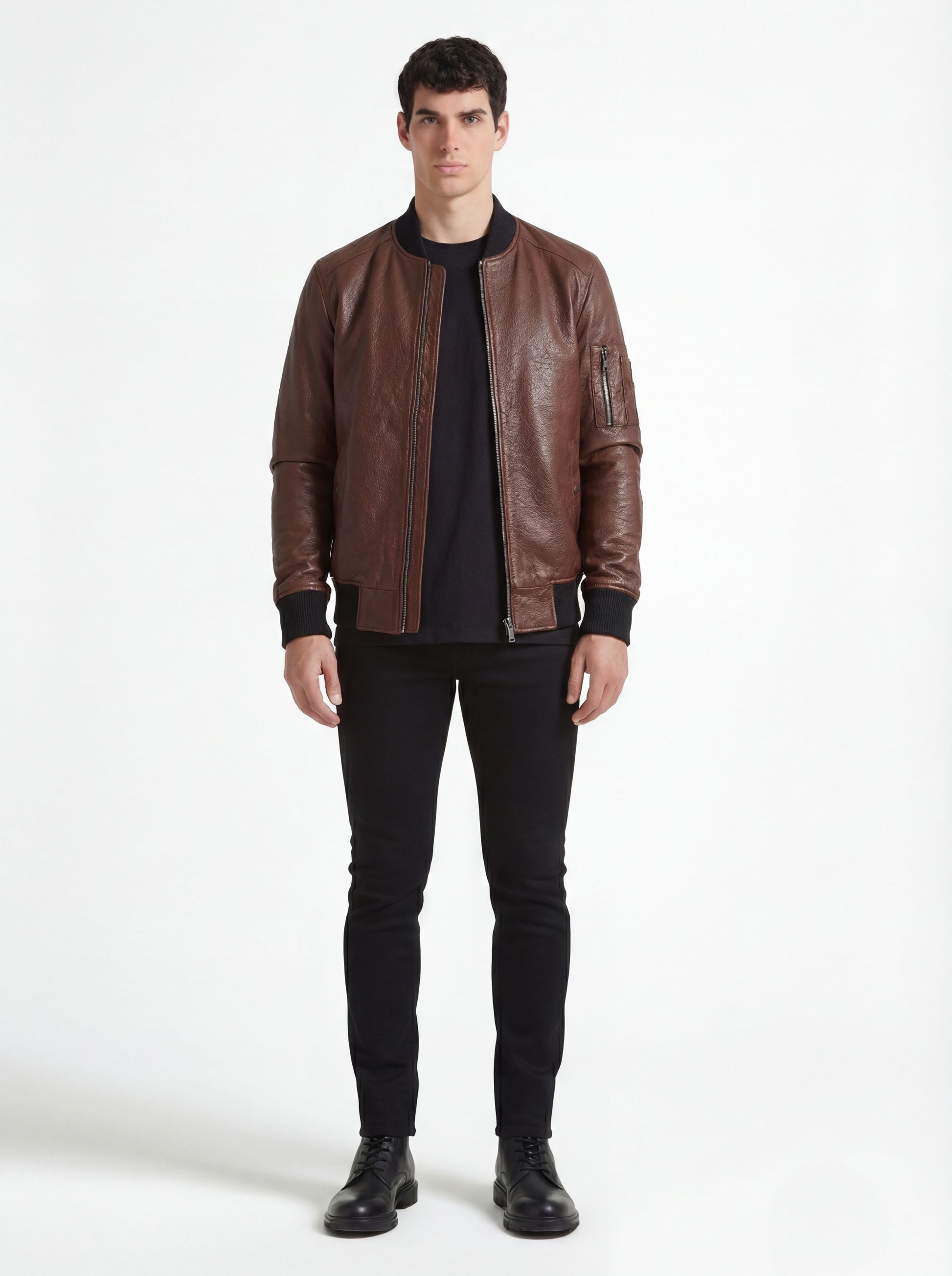 Male model wearing Maverick Vector brown leather bomber jacket, casual fit, styled with black crew neck t-shirt and black skinny jeans. Maverick Jacket.