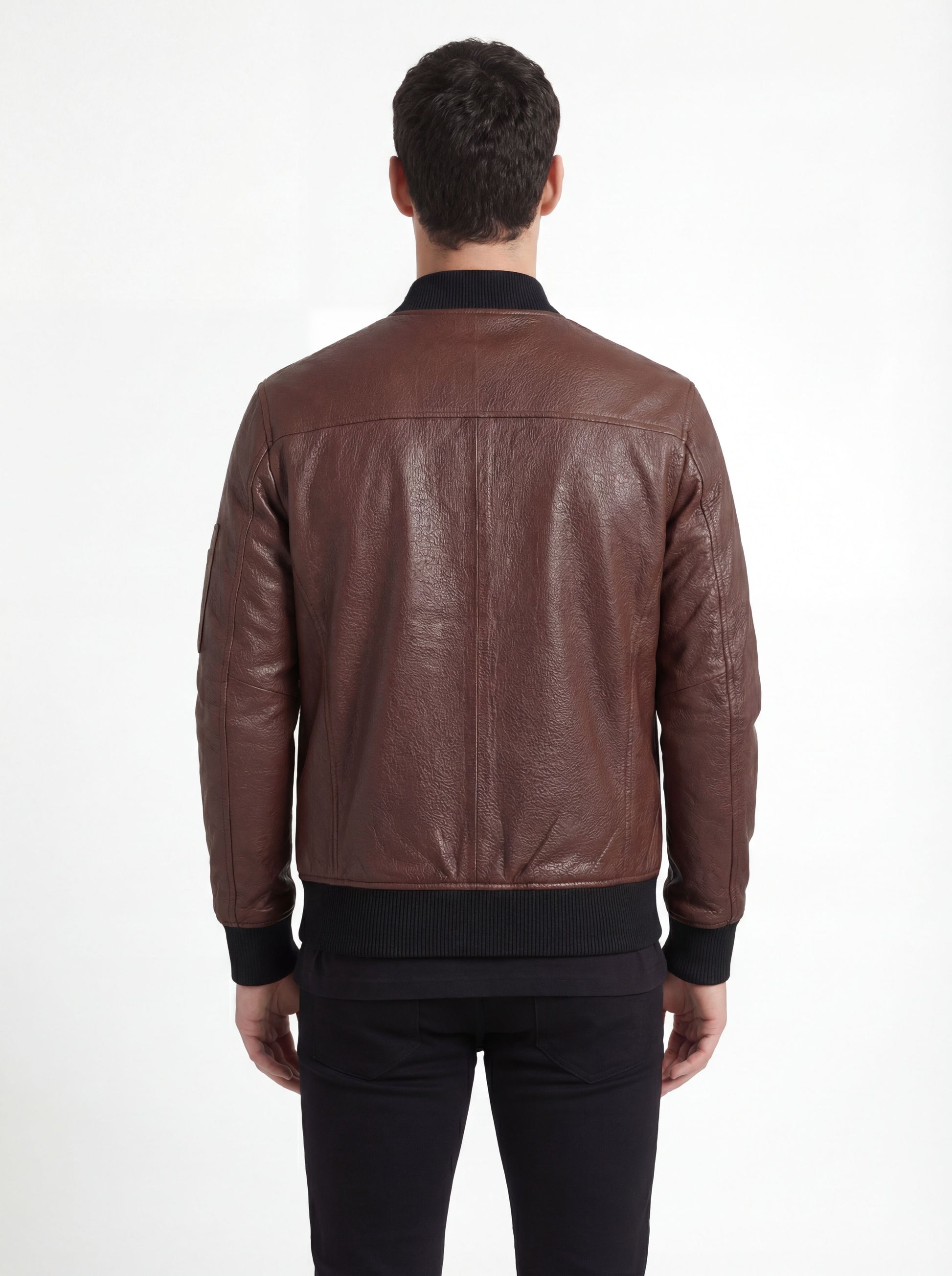 Rear view of male model wearing Maverick Vector brown leather bomber jacket showing fitted shoulder silhouette and ribbed hem styling. Maverick Jacket.