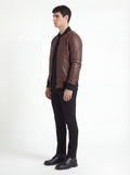 Side profile of Maverick Vector bomber jacket showing zippered sleeve utility pocket and straight torso fit. Maverick Jacket.