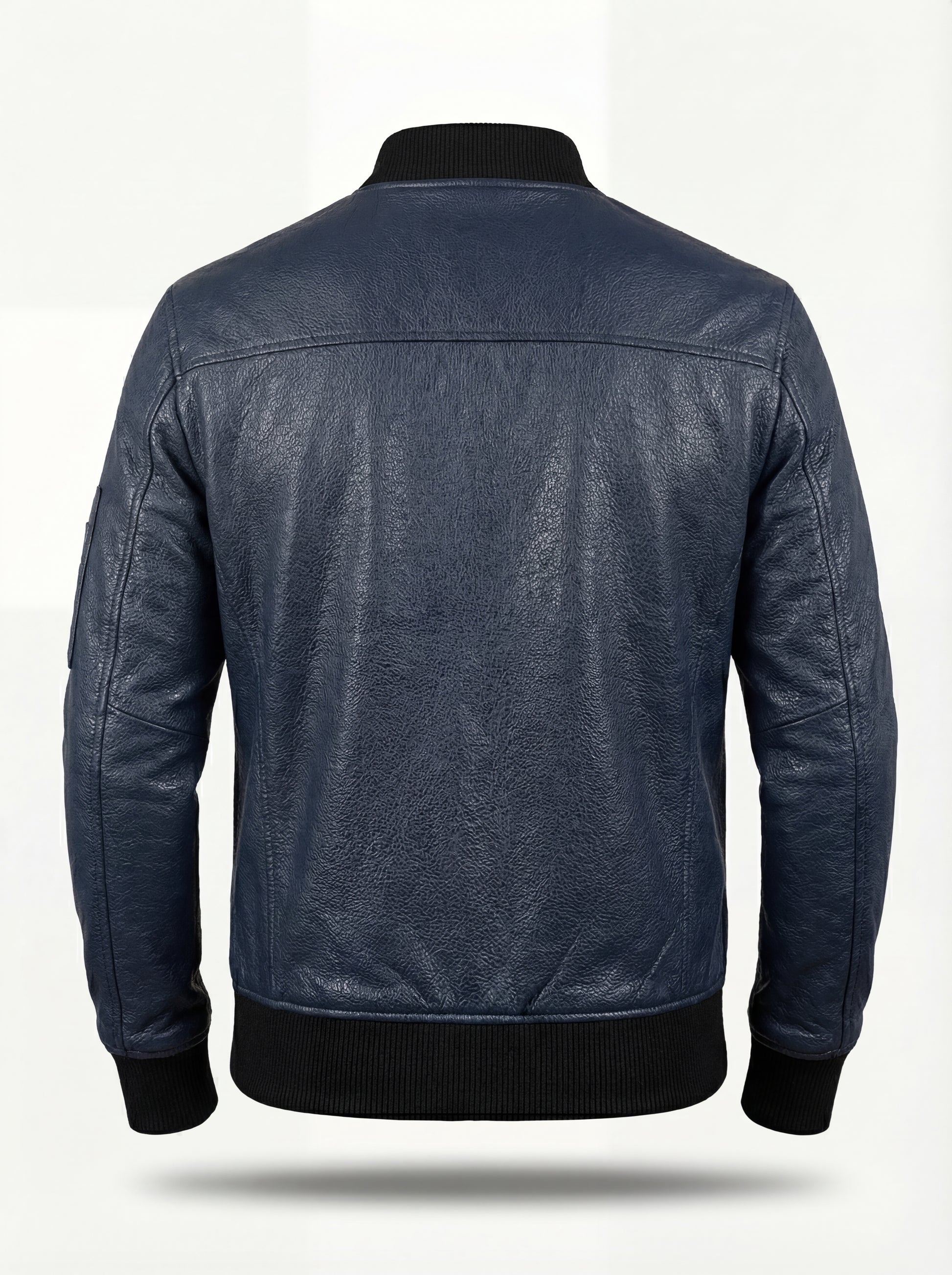 Rear view of navy blue leather MA-1 bomber jacket showing horizontal back yoke and black ribbed knit waistband. The Stratus by Maverick Jacket.