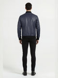 Rear view of male model wearing Maverick Stratus navy blue leather bomber showing fitted shoulder silhouette and ribbed waistband styling. Maverick Jacket.