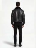 Rear view of male model wearing Maverick Phantom Black Leather Flight Jacket showing broad shoulder fit and shearling hem detail. Maverick Jacket.
