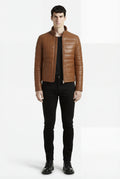 Male model wearing Maverick Terrano padded leather jacket, slim fit, styled with black crewneck t-shirt and black slim trousers. Maverick Jacket.