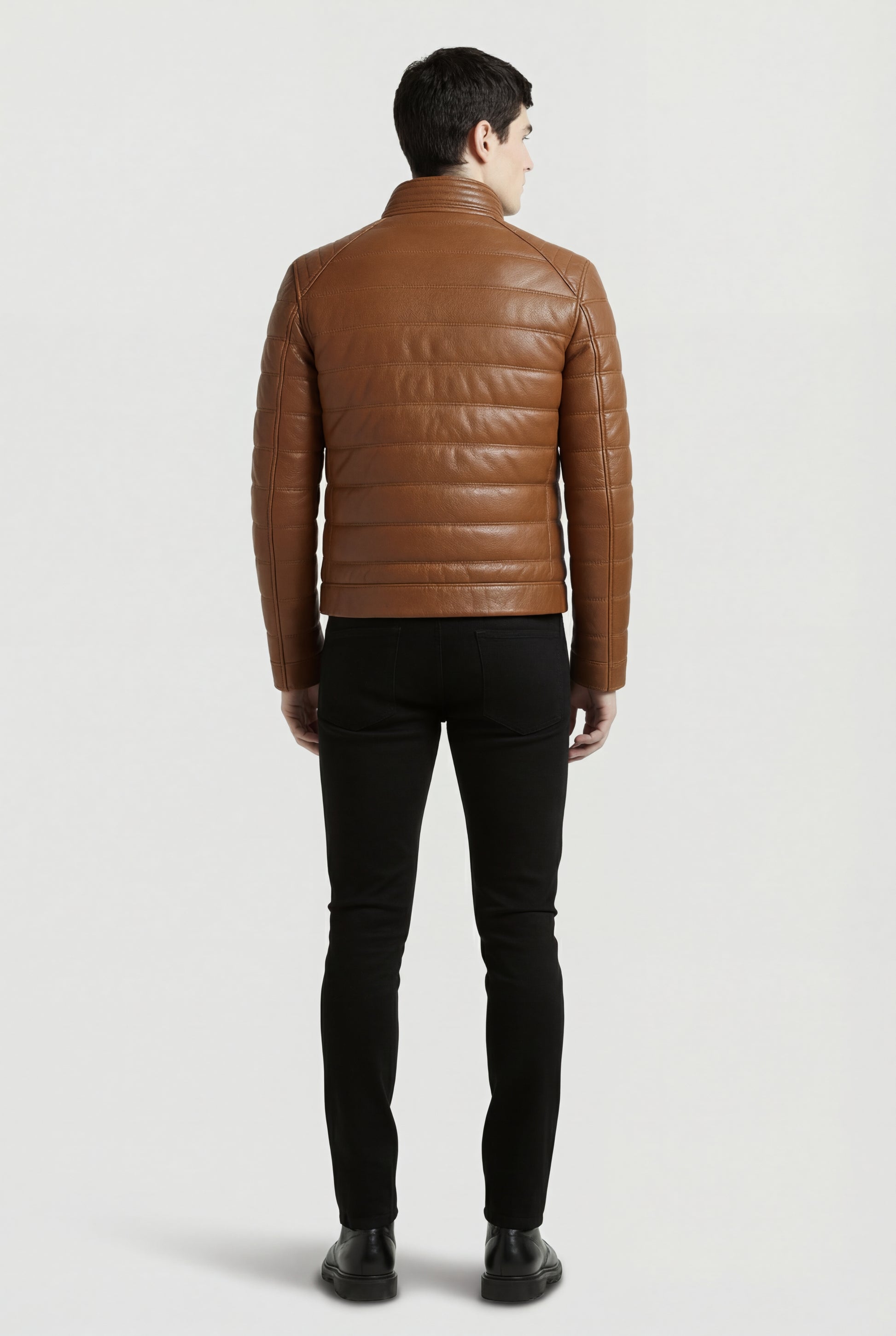 Rear view of male model wearing Maverick Terrano padded leather jacket showing structured shoulder fit and quilted back styling. Maverick Jacket.