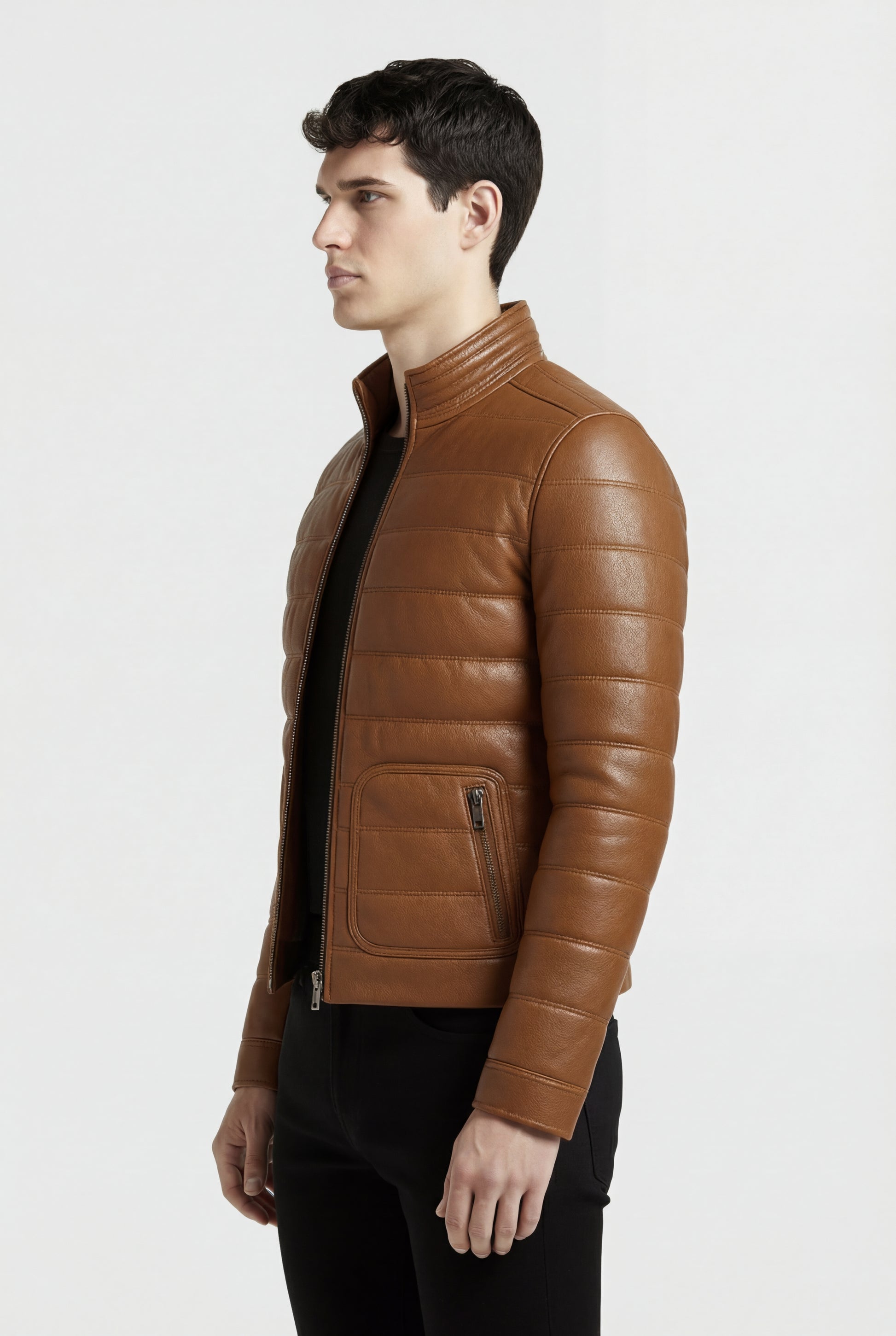 Side profile of Maverick Terrano padded leather jacket showing horizontal sleeve quilting and straight torso silhouette. Maverick Jacket.
