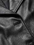 Macro shot of pebbled black leather texture and lapel buttonhole stitching on trench coat. Maverick Kensington.