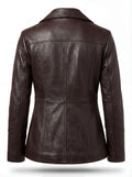 Rear view of brown leather trench coat showing structured yoke and vertical princess seams. Maverick Belgravia.