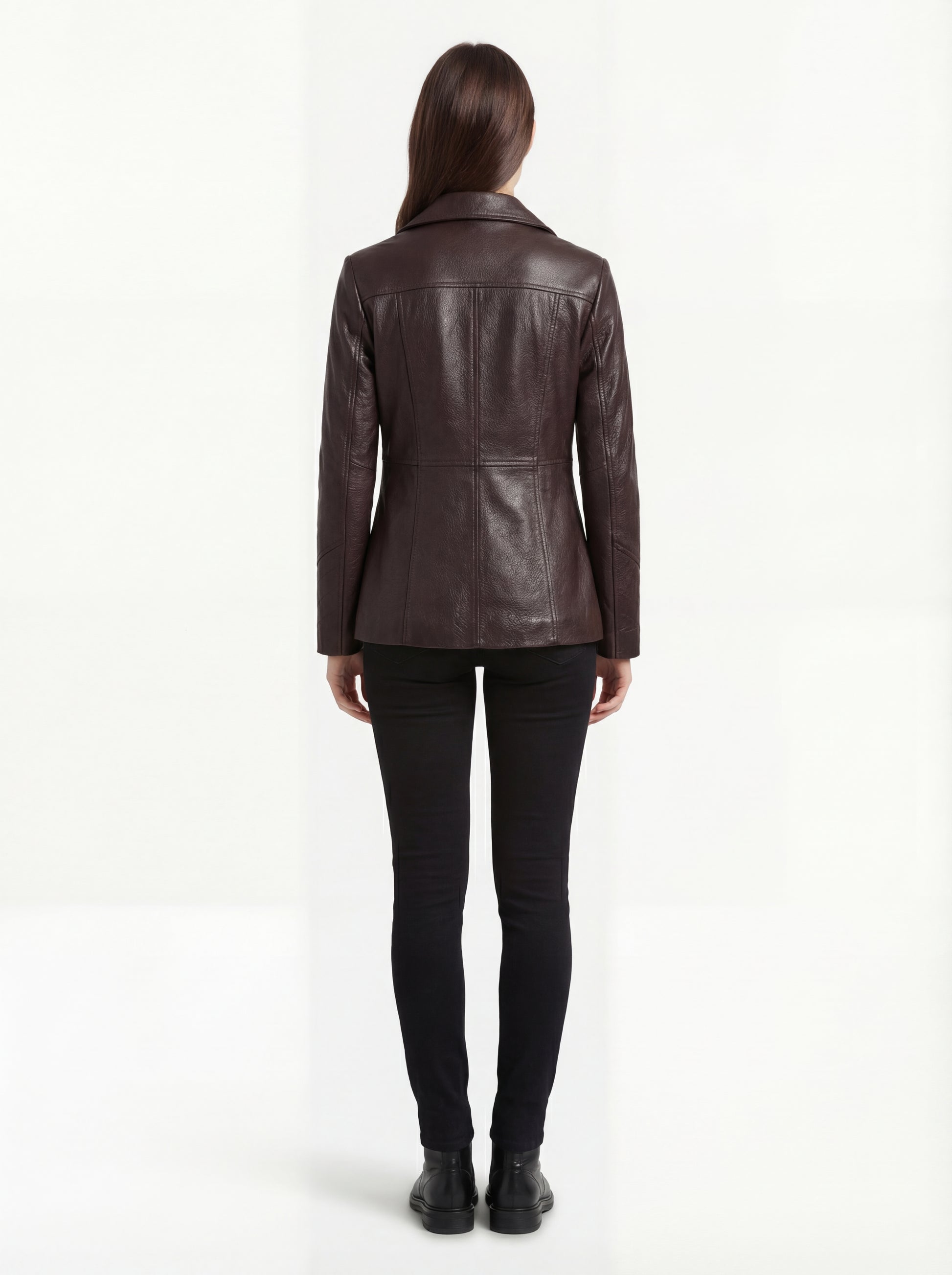 Rear view of female model wearing Maverick Belgravia leather trench coat showing fitted shoulders and vertical paneling. Maverick Belgravia.