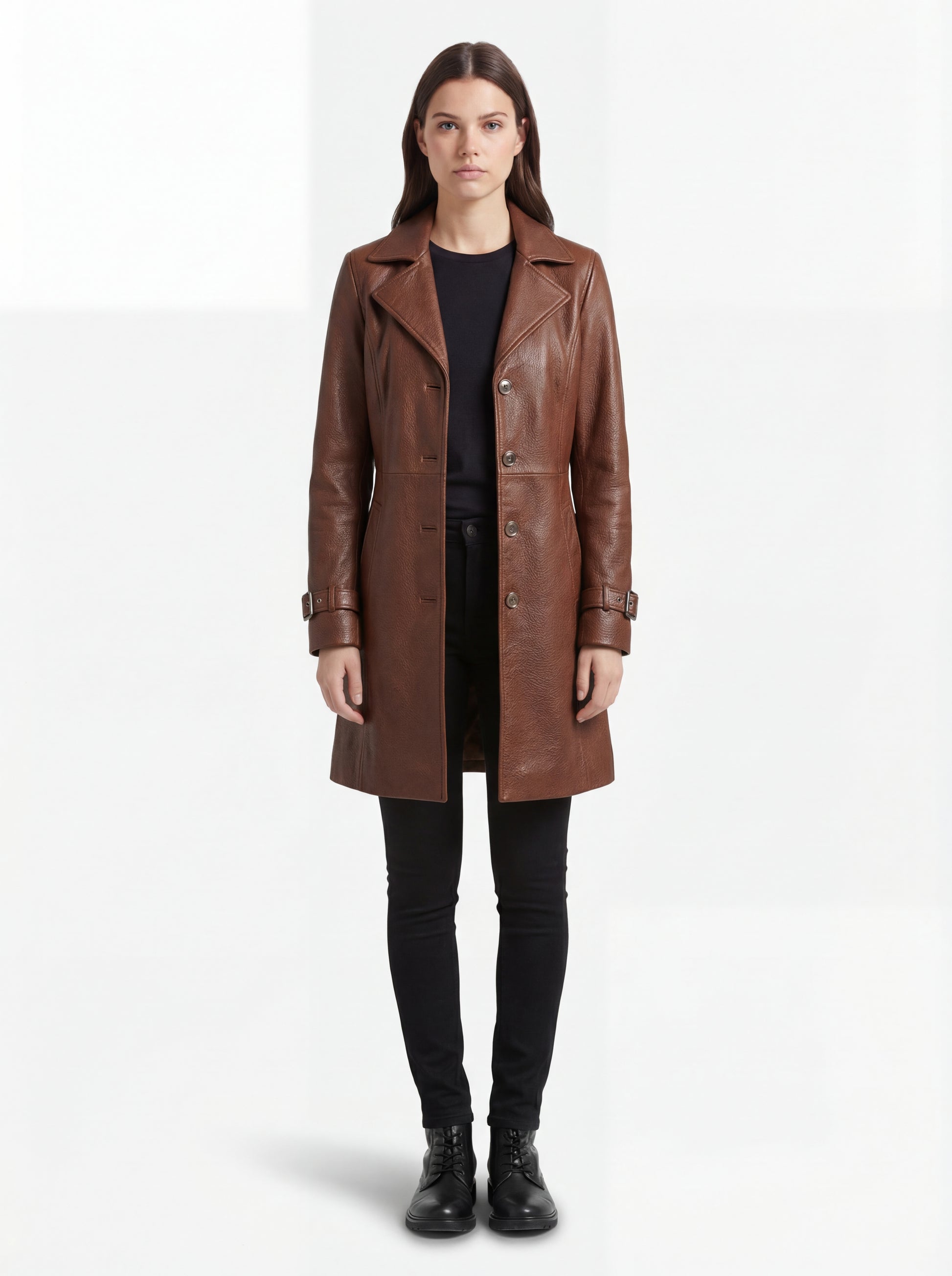 Female model wearing Maverick York cognac leather walker coat, tailored fit, styled over a turtleneck sweater with slim indigo denim jeans. Maverick Jacket.