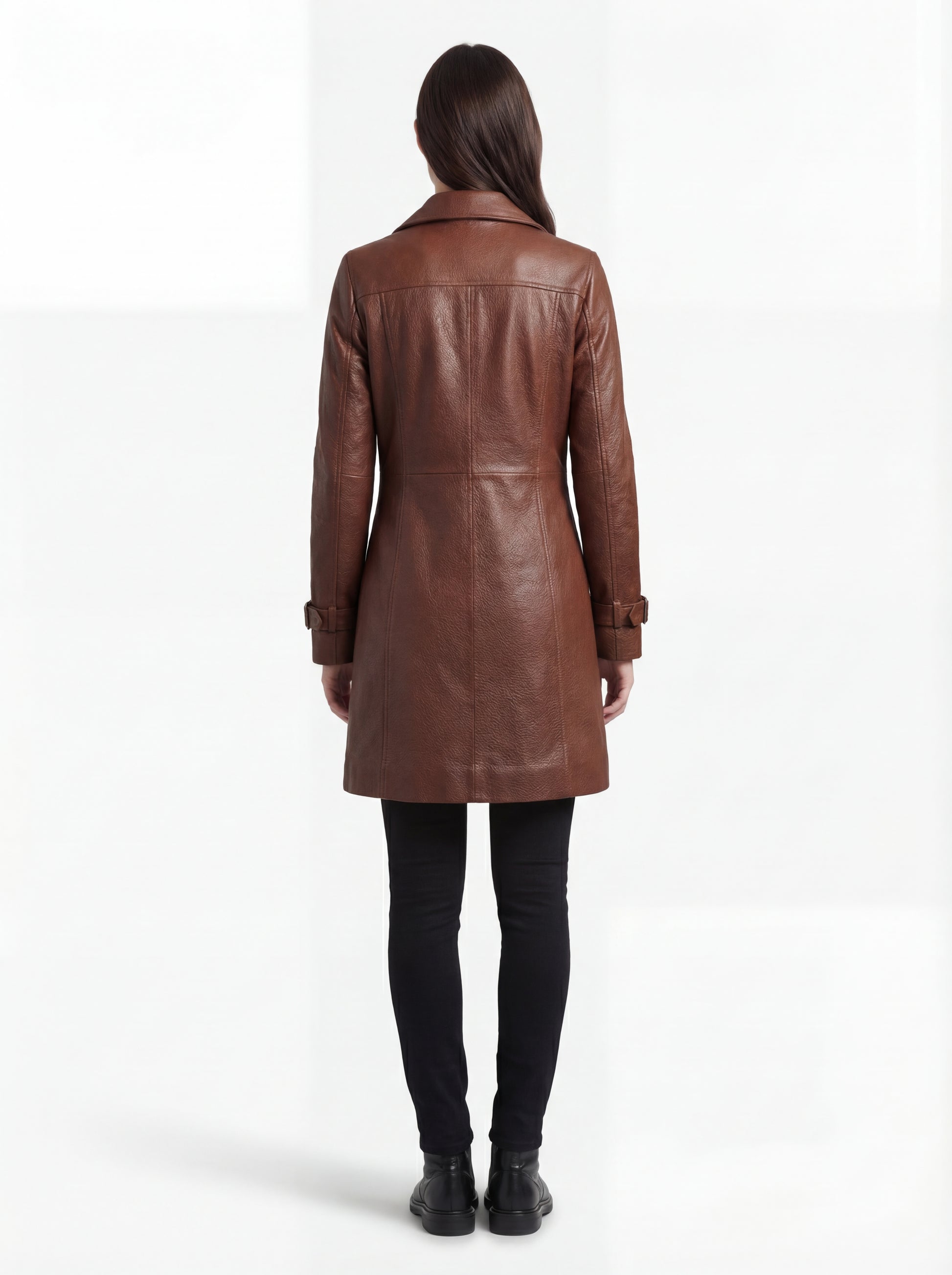 Female model wearing Maverick York cognac leather walker coat, tailored fit, styled over a turtleneck sweater with slim indigo denim jeans. Maverick Jacket.