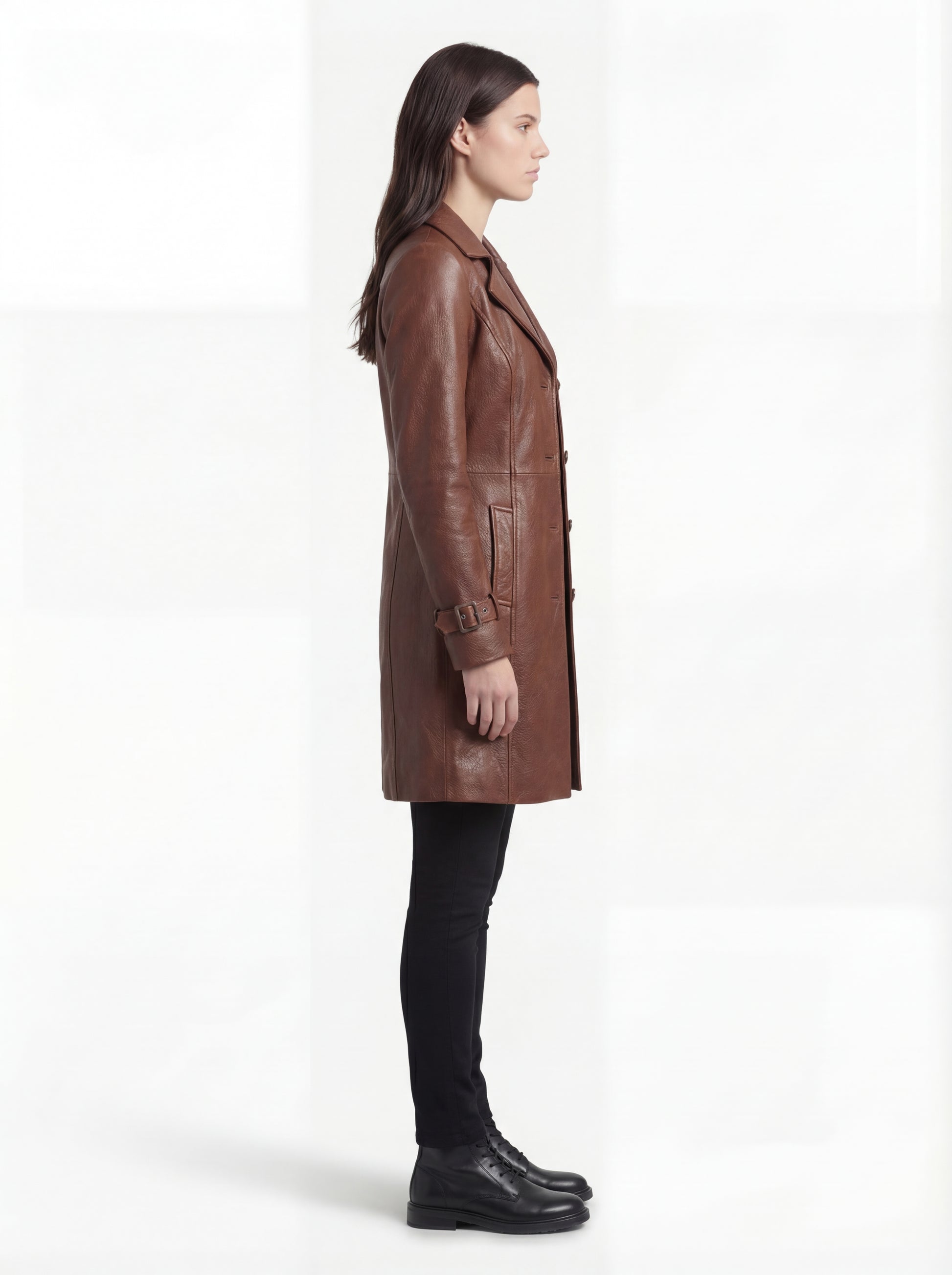 Side profile of Maverick York leather walker coat showing long sleeve structure and mid-thigh length silhouette. Maverick Jacket.