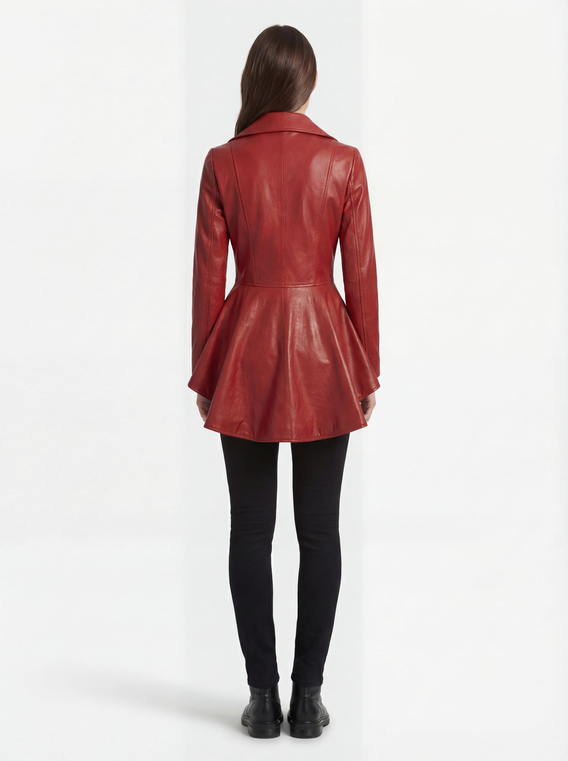 Rear view of female model wearing Maverick Valencia leather peplum coat showing tailored waist fit and flared back drape. Maverick Valencia.
