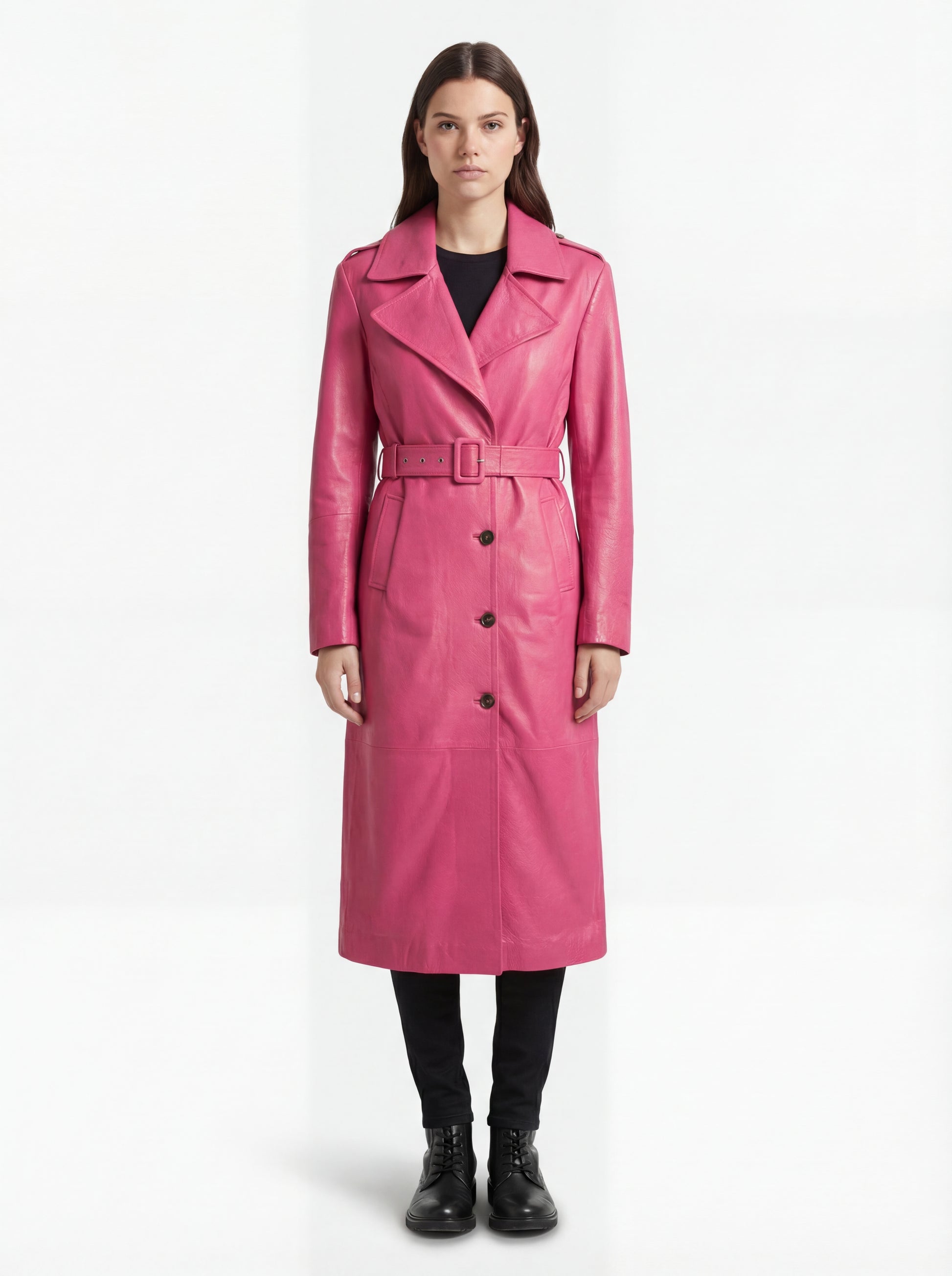 Female model wearing Maverick Eira pink leather trench coat, tailored fit, styled over a white blouse with white wide-leg trousers. Maverick Jacket.