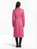 Rear view of female model wearing Maverick Eira pink leather trench coat showing structured shoulder fit and elegant back drape. Maverick Jacket.