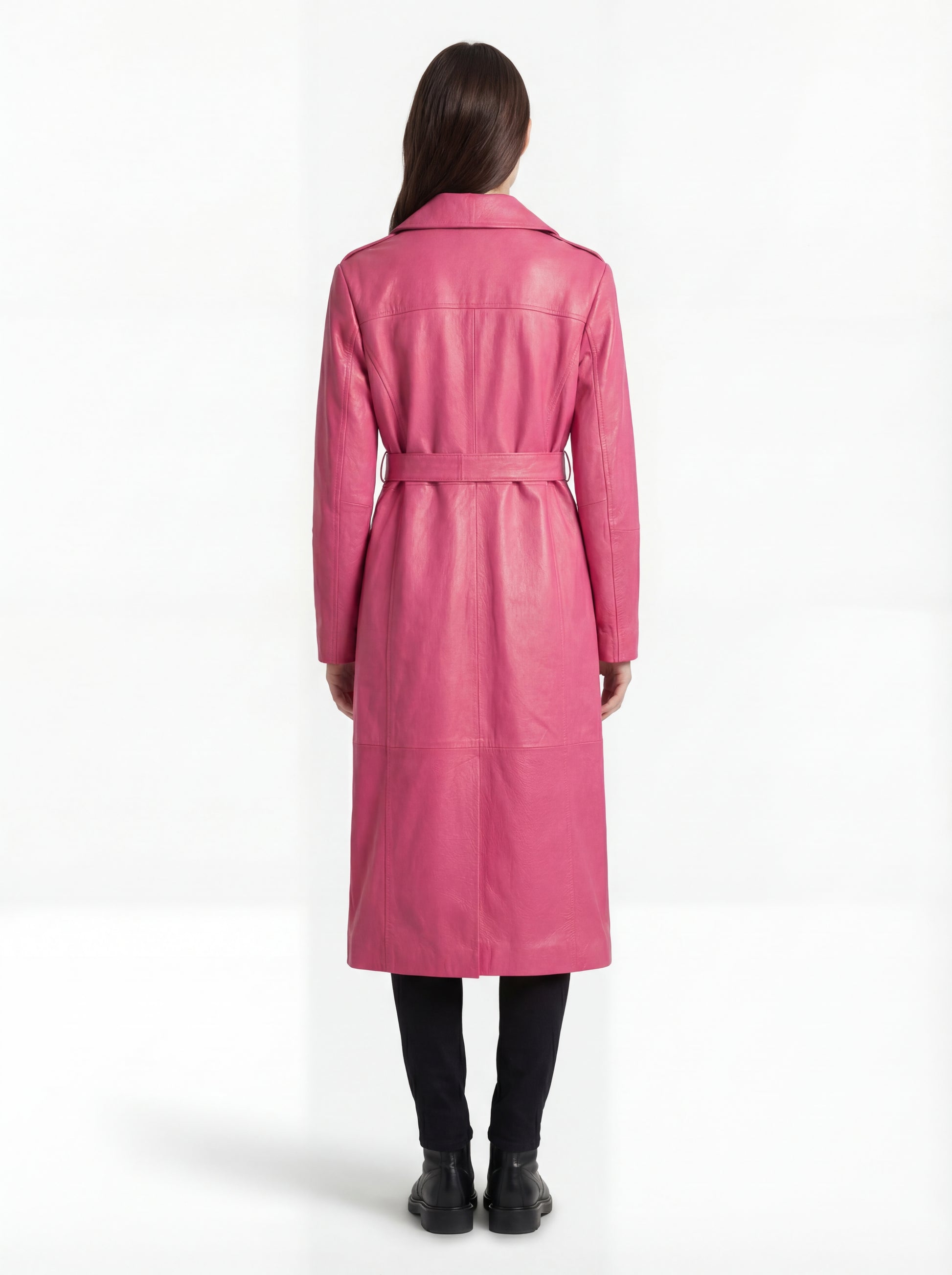 Rear view of female model wearing Maverick Eira pink leather trench coat showing structured shoulder fit and elegant back drape. Maverick Jacket.