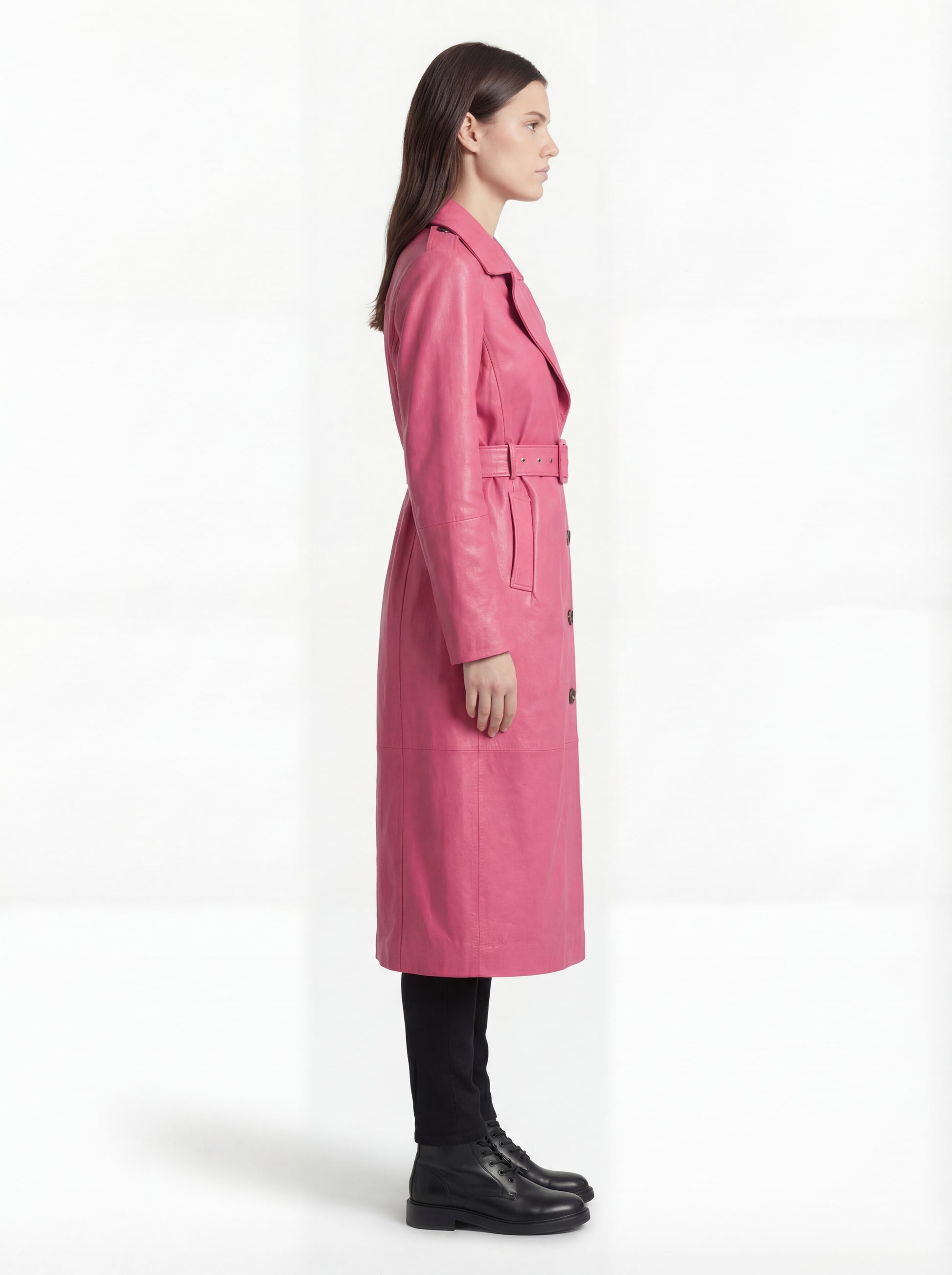 Side profile of Maverick Eira leather trench coat showing adjustable cuff straps and belted waist silhouette. Maverick Jacket.