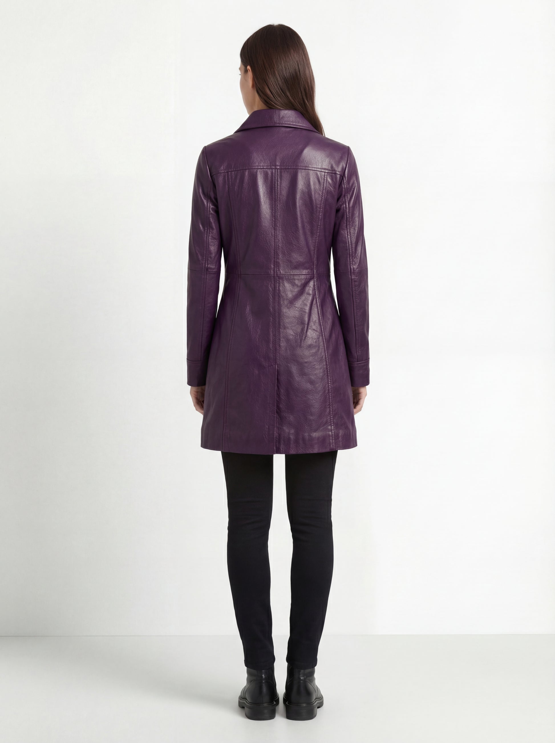Rear view of female model wearing Maverick Helena leather walker coat showing fitted shoulders and longline silhouette. Maverick Helena.