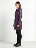 Side profile of Maverick Helena leather walker coat showing long sleeve structure and mid-thigh length silhouette. Maverick Helena.
