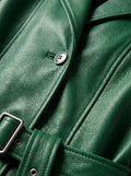 Macro shot of smooth green leather texture and matching waist belt buckle on trench coat. The Aspen by Maverick Jacket.