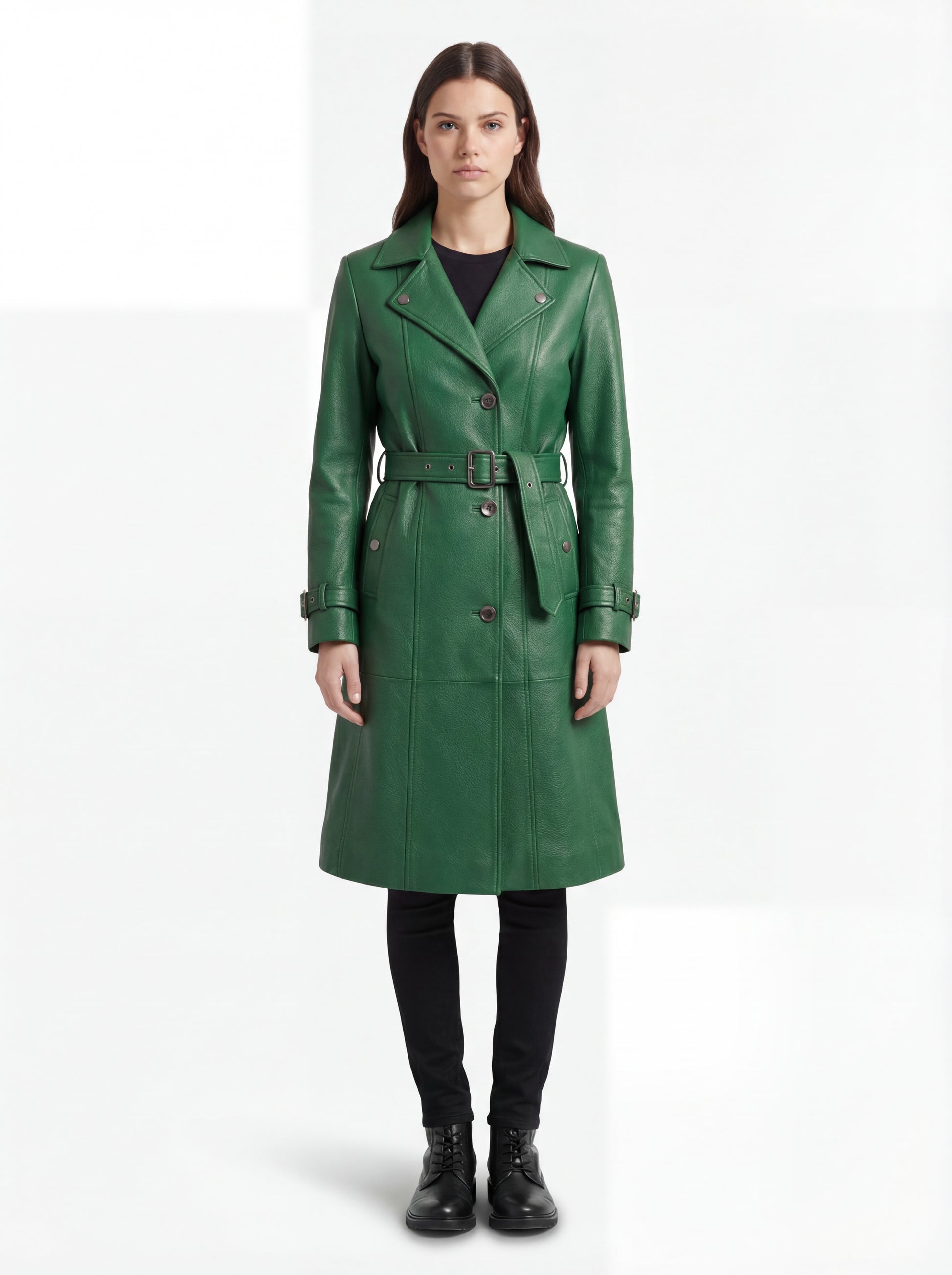 Female model wearing Maverick Aspen green leather trench coat, tailored fit, styled over a black turtleneck with wide-leg trousers. Maverick Jacket.