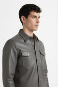 Side profile of Maverick Grayson leather western shirt showing long sleeve cuff structure and straight silhouette. Maverick Jacket.