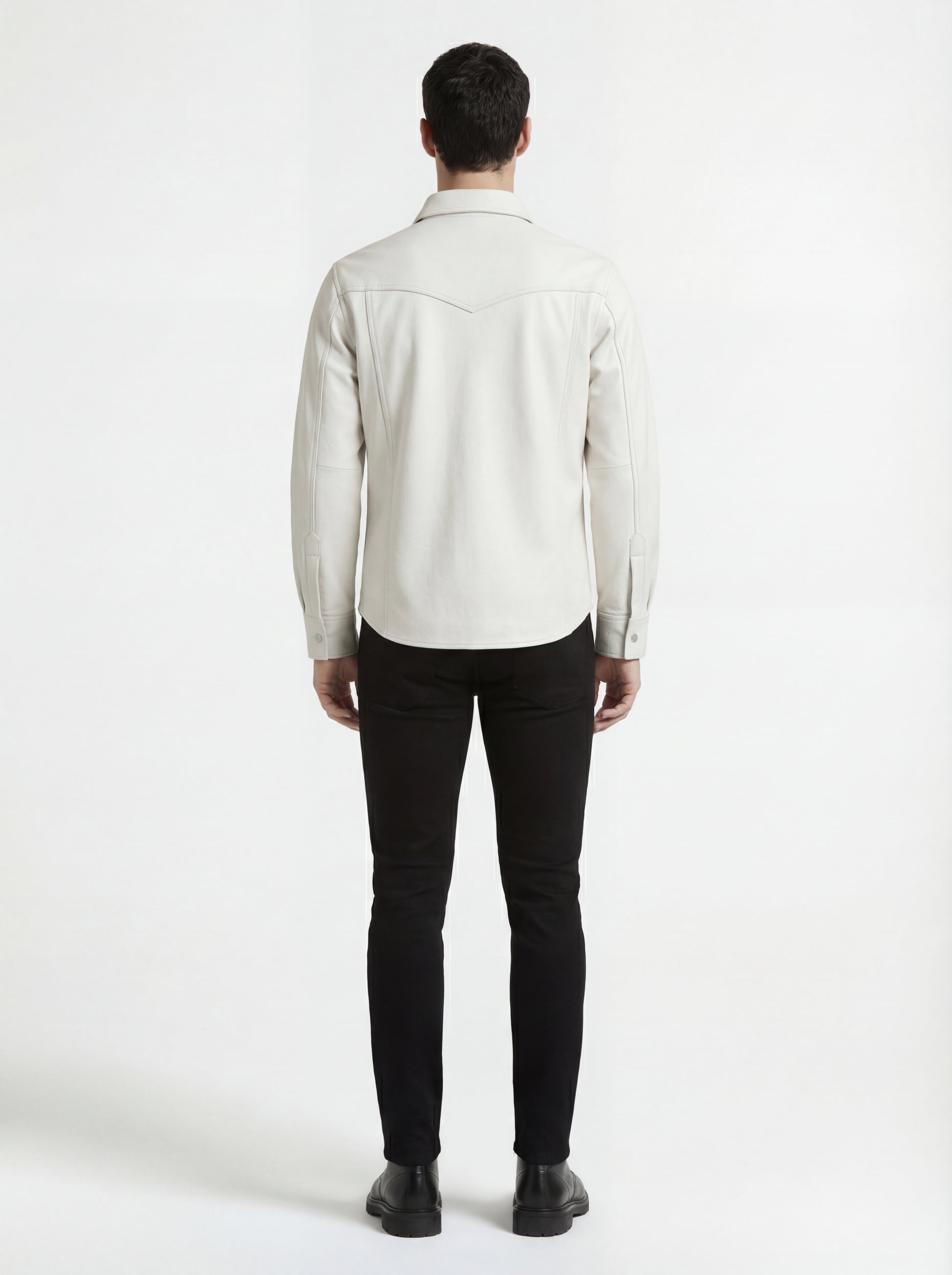Rear view of male model wearing Maverick Tiernan off-white leather western shirt showing tailored shoulder fit and western yoke styling. Maverick Jacket.
