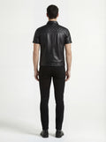 Rear view of male model wearing Maverick Mason short-sleeve leather shirt showing quilted yoke fit and straight hem styling. Maverick Jacket.