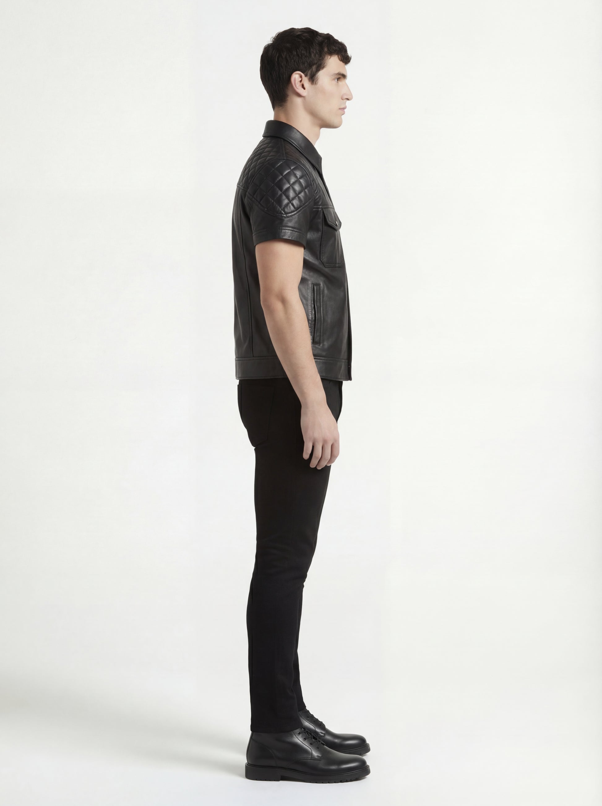 Side profile of Maverick Mason short-sleeve leather shirt showing quilted shoulder structure and slim silhouette. Maverick Jacket.