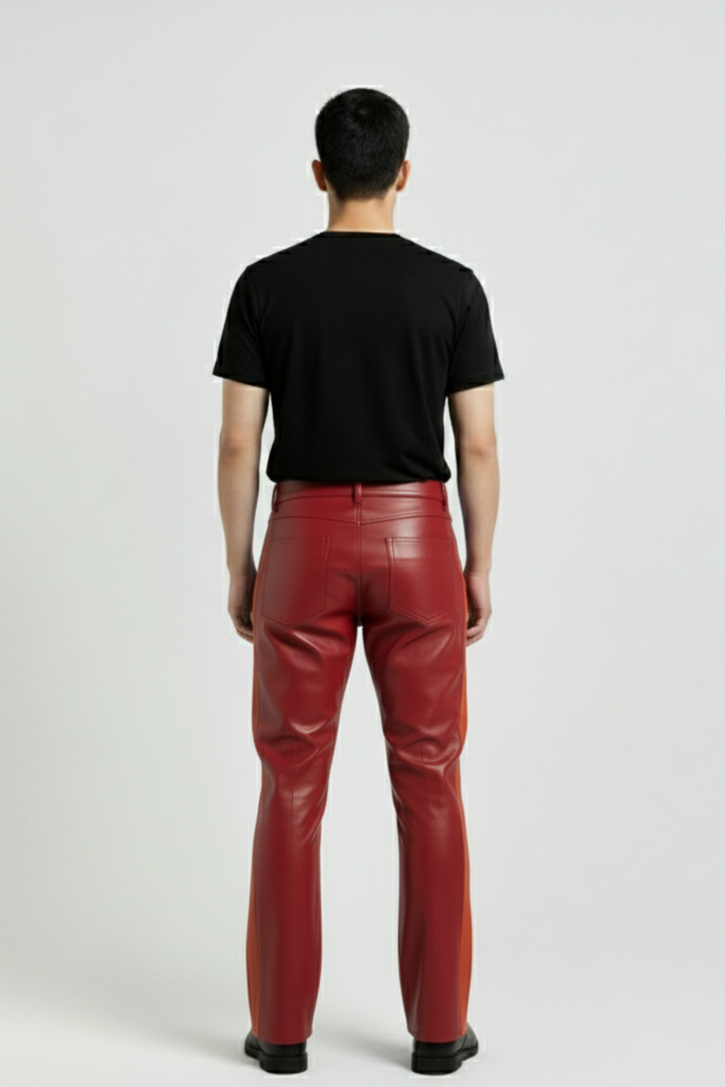 Rear view of male model wearing Maverick Jagger two-tone leather racing pants showing tailored seat fit and straight leg structure. Maverick Jacket.