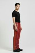 Side profile of male model wearing Maverick Jagger two-tone leather racing pants showing contrasting side stripe and straight silhouette. Maverick Jacket.