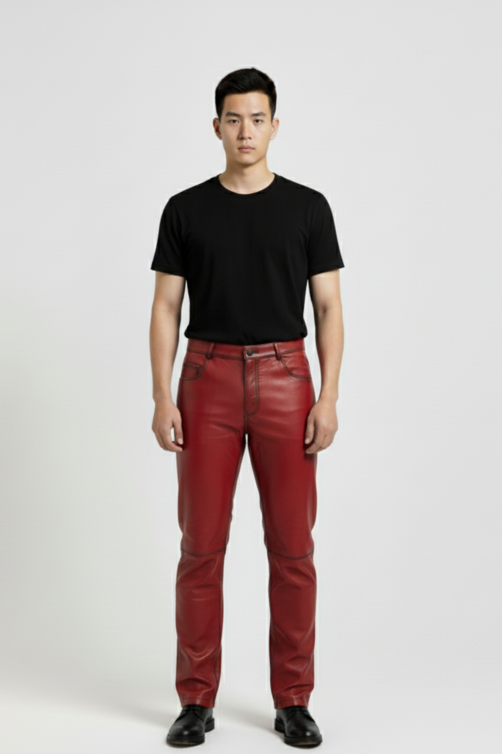 Male model wearing Maverick Knox red leather pants, straight fit, styled with black crew neck t-shirt and black leather boots. Maverick Jacket.