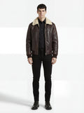Male model wearing Maverick Nomad aviator jacket, classic fit, styled with black button-down shirt and black slim jeans. Maverick Jacket.