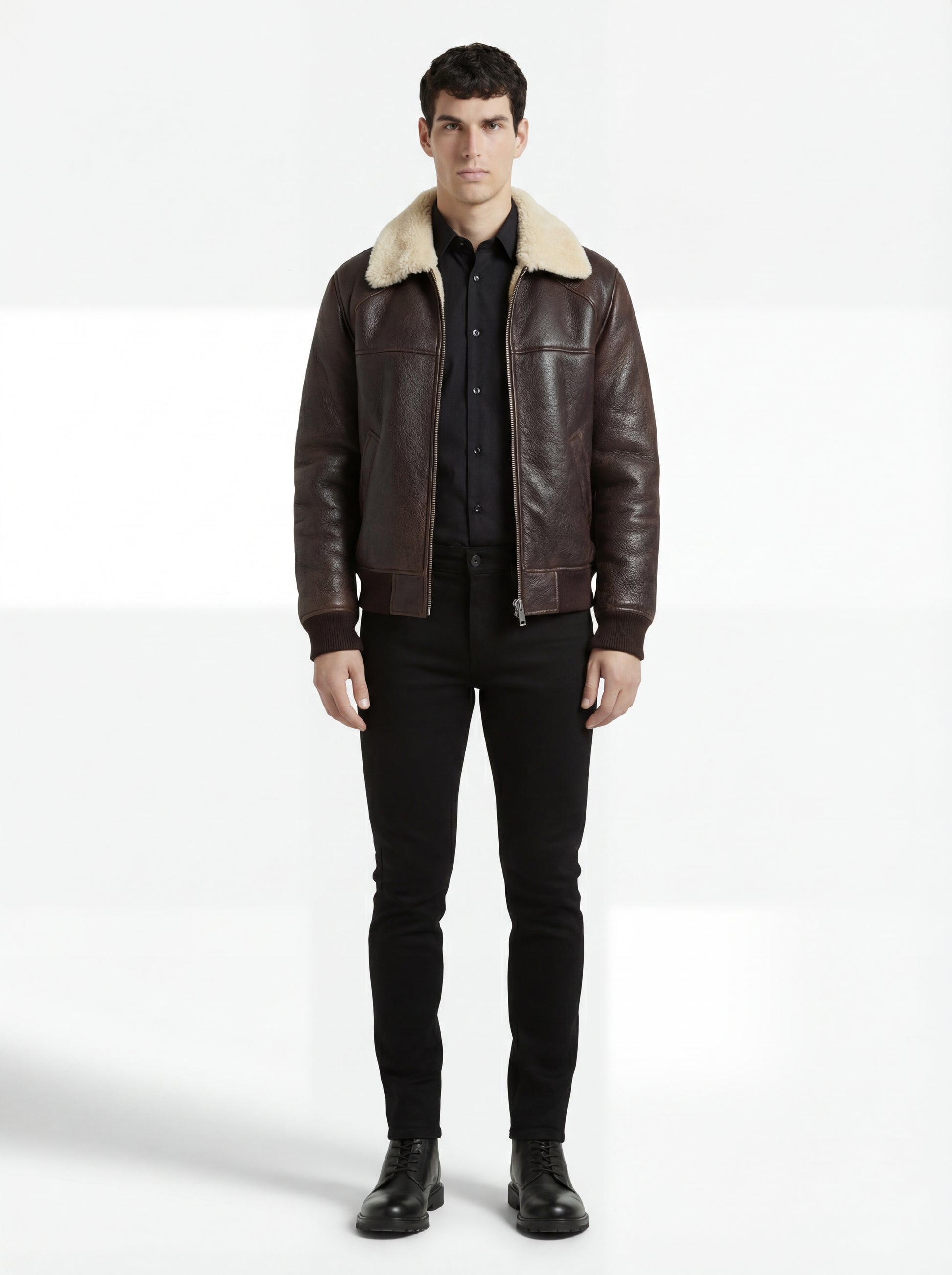 Male model wearing Maverick Nomad aviator jacket, classic fit, styled with black button-down shirt and black slim jeans. Maverick Jacket.
