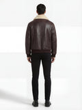 Rear view of male model wearing Maverick Nomad aviator jacket showing broad shoulder fit and ribbed hem drape. Maverick Jacket.