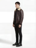 Side profile of Maverick Nomad aviator jacket showing ribbed cuff structure and relaxed bomber silhouette. Maverick Jacket.