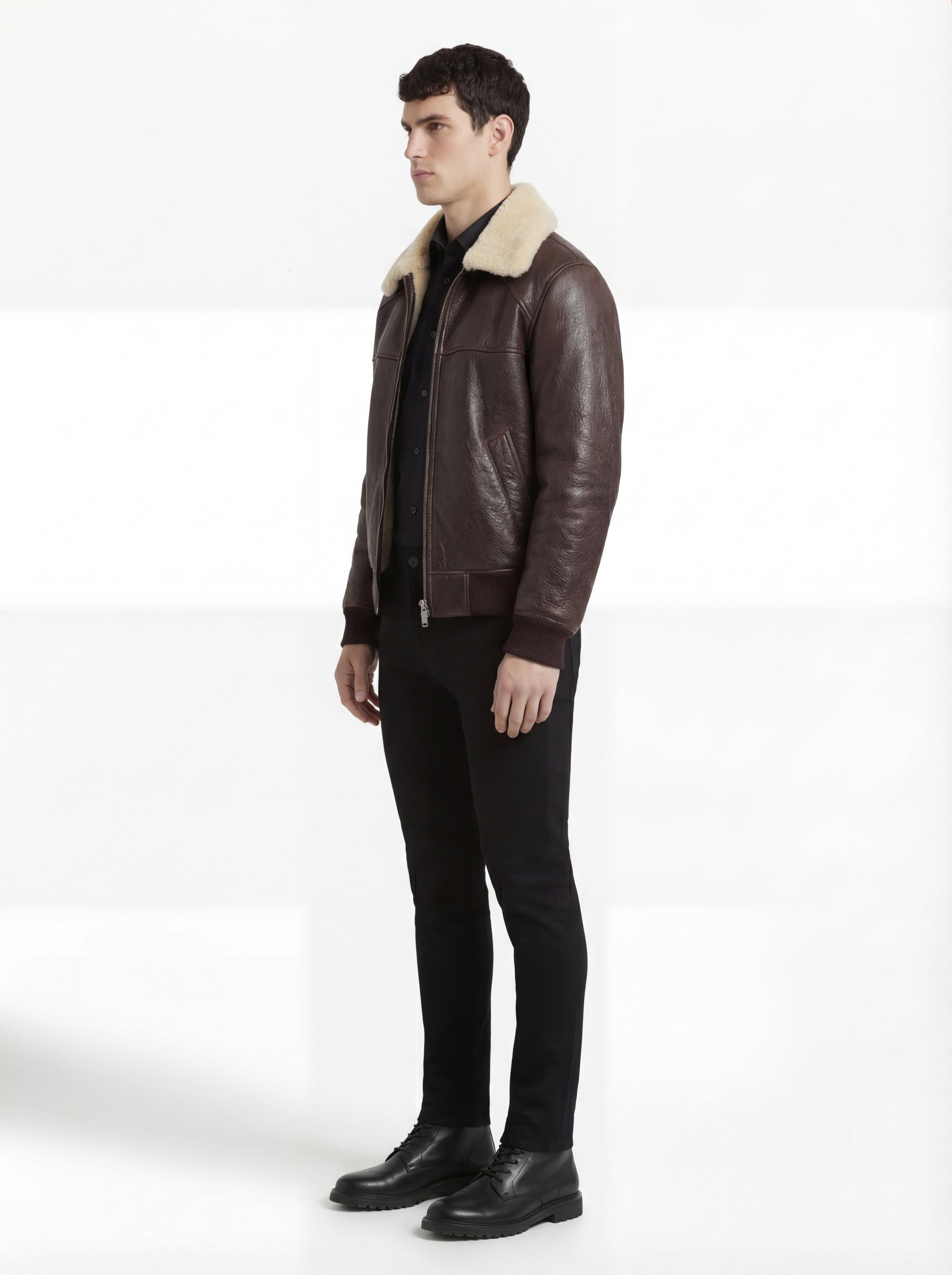 Side profile of Maverick Nomad aviator jacket showing ribbed cuff structure and relaxed bomber silhouette. Maverick Jacket.