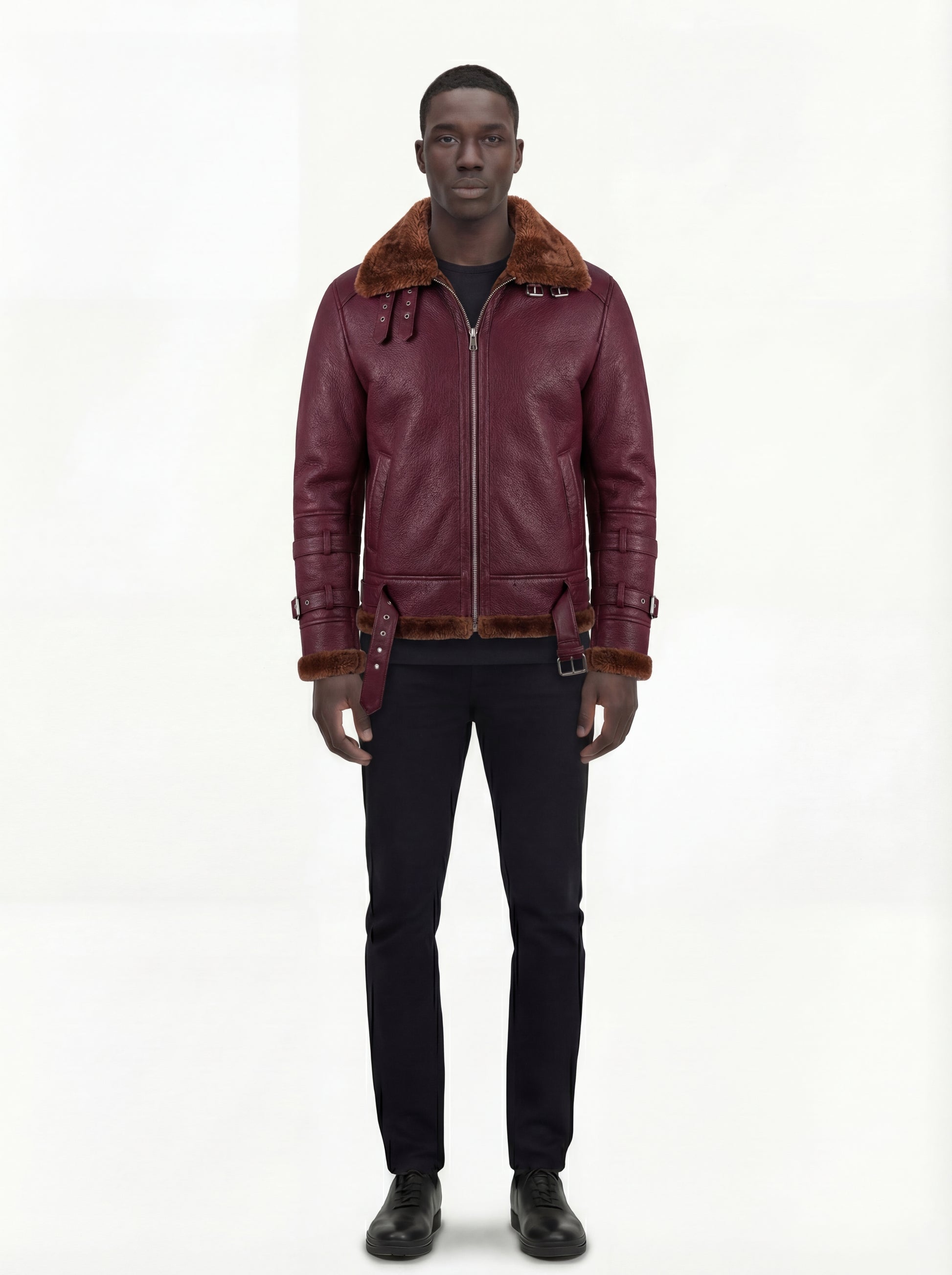 Male model wearing Maverick Garnet shearling B3 jacket, regular fit, styled with black crewneck top and slim black trousers. Maverick Jacket.
