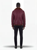 Rear view of male model wearing Maverick Garnet shearling B3 jacket showing broad shoulder fit and shearling-trimmed hemline. Maverick Jacket.