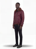 Side profile of Maverick Garnet shearling B3 jacket showing dual sleeve buckle straps and straight torso silhouette. Maverick Jacket.