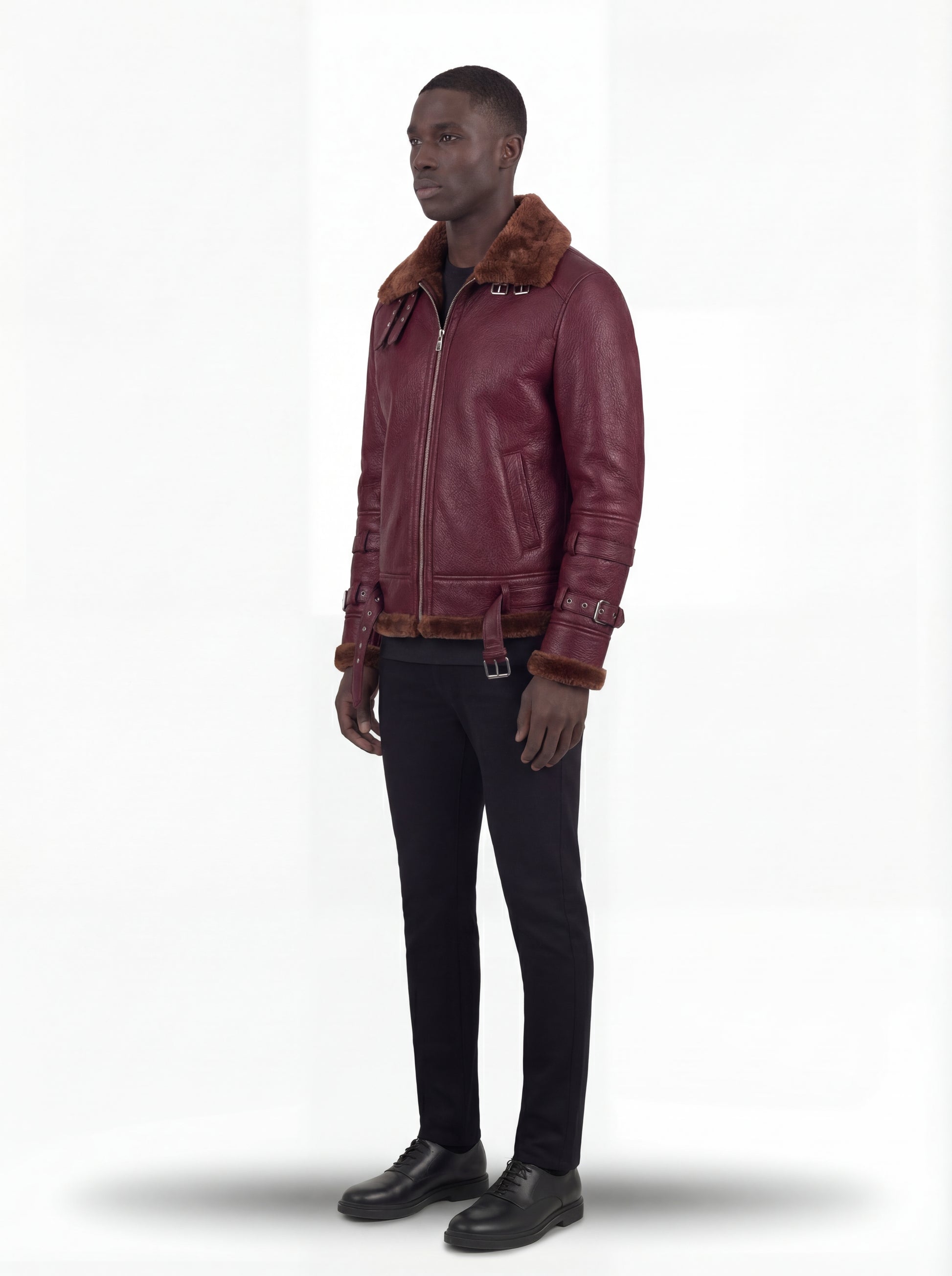 Side profile of Maverick Garnet shearling B3 jacket showing dual sleeve buckle straps and straight torso silhouette. Maverick Jacket.