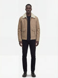 Male model wearing Maverick Dune shearling jacket, regular fit, styled with black crewneck t-shirt and black slim trousers. Maverick Jacket.
