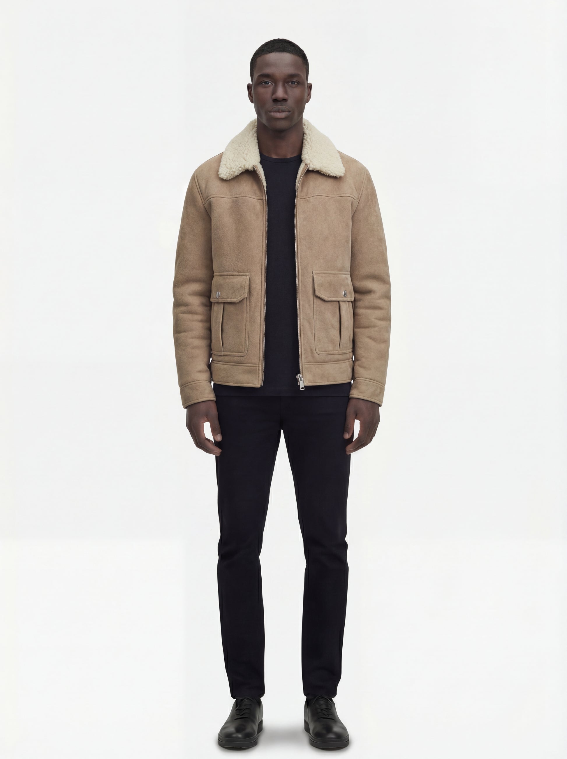 Male model wearing Maverick Dune shearling jacket, regular fit, styled with black crewneck t-shirt and black slim trousers. Maverick Jacket.