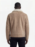 Rear view of male model wearing Maverick Dune shearling jacket showing structured shoulder fit and straight hem drape. Maverick Jacket.