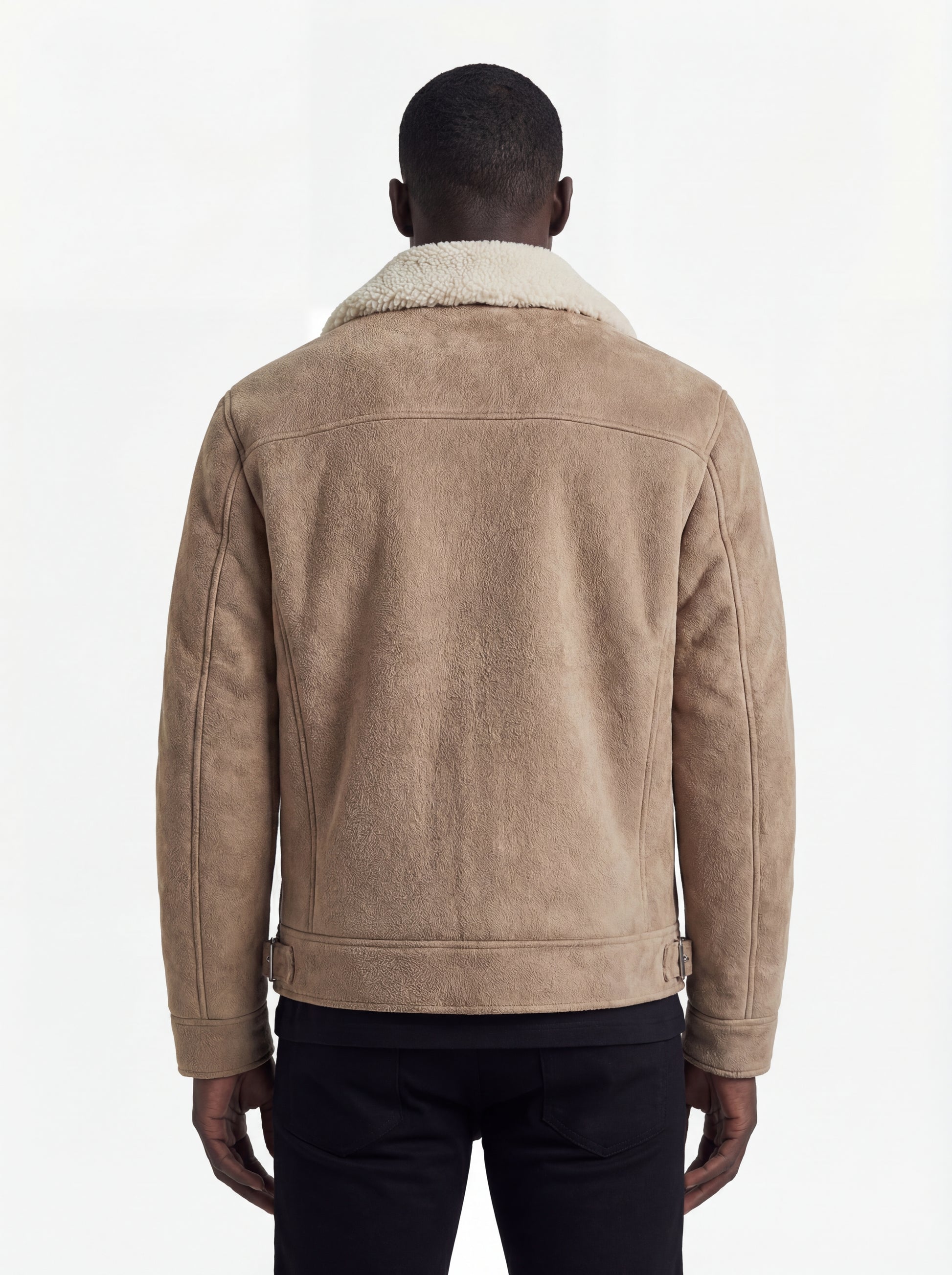 Rear view of male model wearing Maverick Dune shearling jacket showing structured shoulder fit and straight hem drape. Maverick Jacket.