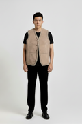 Male model wearing Maverick Owen shearling vest, layered fit, styled over a plaid flannel shirt and raw indigo denim. Maverick Jacket.