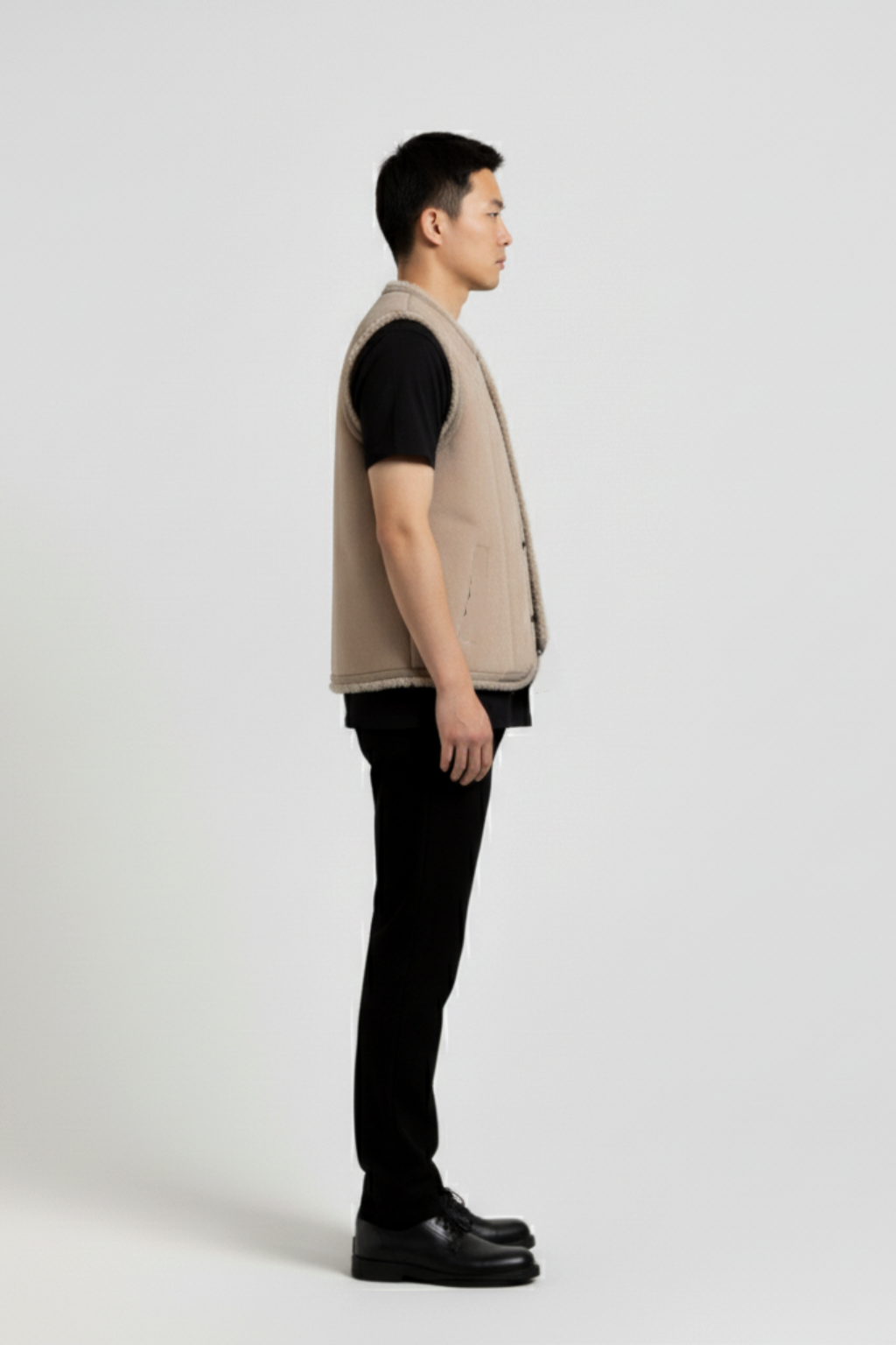 Side profile of Maverick Owen shearling vest showing deep armhole cut and straight torso silhouette. Maverick Jacket.