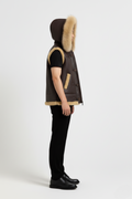 Side profile of Maverick Magnus shearling vest showing deep armhole cut and thick hood silhouette. Maverick Jacket.